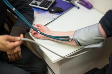 Patient having their blood pressure taken by their GP