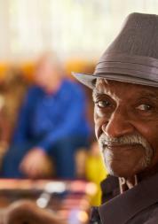 Man smiling at the camera in a care home